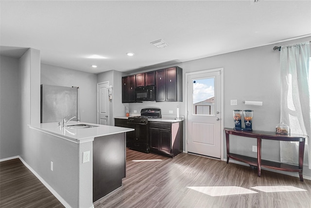 5625 Mcclelland St, Forney, TX 75126 - kitchen with black appliances, a sink, wood finished floors, light countertops, and baseboards