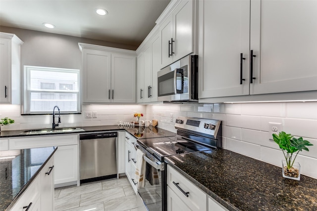 kitchen with stainless steel appliances, marble finish floor, backsplash, and a sink