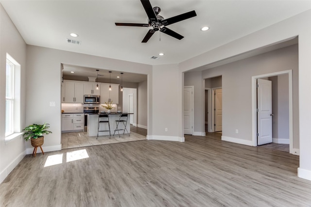 entryway with baseboards, recessed lighting, wood finished floors, and ceiling fan