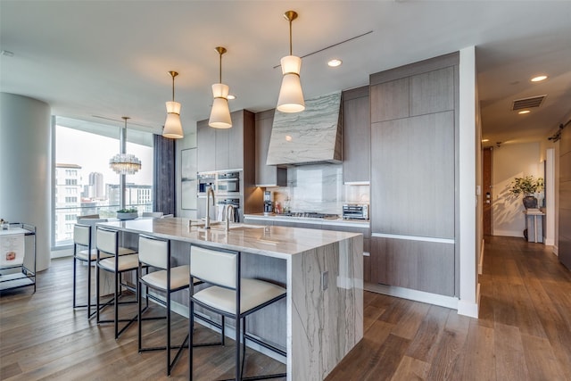 kitchen featuring dark wood-type flooring, modern cabinets, visible vents, and stainless steel appliances