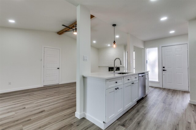 8212 Greenhollow Ln, Dallas, TX 75240 - kitchen with stainless steel appliances, a sink, light wood finished floors, recessed lighting, and white cabinetry