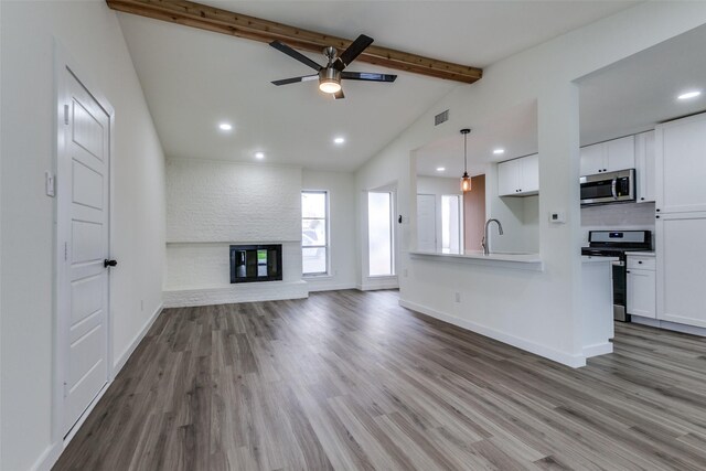 8212 Greenhollow Ln, Dallas, TX 75240 - unfurnished living room featuring ceiling fan, wood finished floors, recessed lighting, baseboards, and a large fireplace