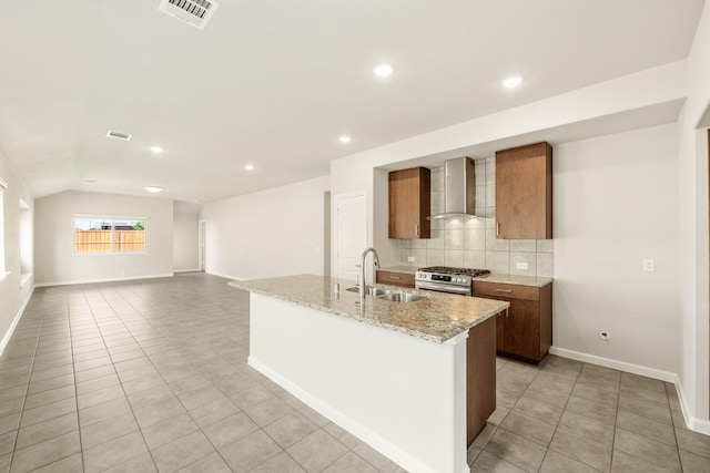 3255 Blossom Trl, Crandall, TX 75114 - kitchen with wall chimney exhaust hood, a sink, stainless steel gas range, light tile patterned floors, and decorative backsplash