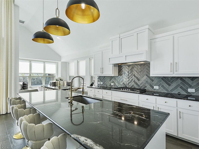 3141 Sunfish St, Prosper, TX 75078 - kitchen featuring a sink, a spacious island, dark wood finished floors, backsplash, and stainless steel gas stovetop