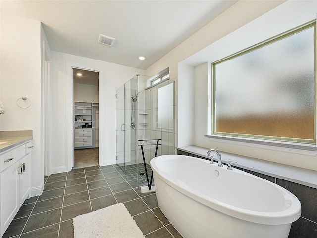 3141 Sunfish St, Prosper, TX 75078 - bathroom with a shower stall, a spacious closet, vanity, a soaking tub, and visible vents