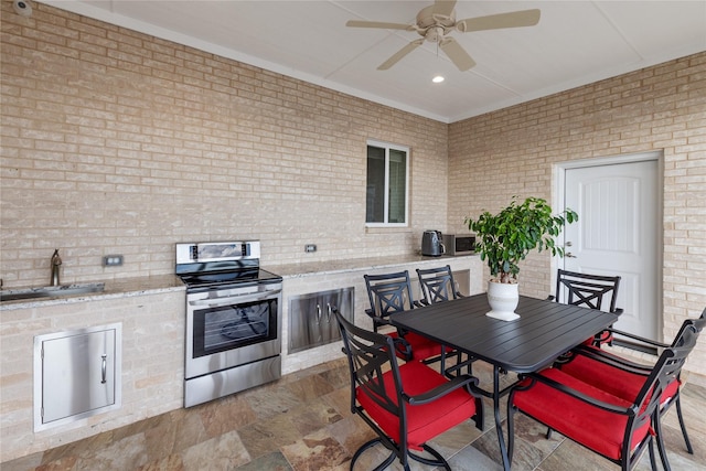 241 Loon Bay Dr, Gun Barrel City, TX 75156 - view of patio with outdoor dining space, an outdoor kitchen, a ceiling fan, and a sink