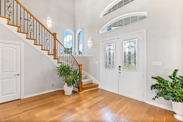 241 Loon Bay Dr, Gun Barrel City, TX 75156 - entrance foyer with a towering ceiling, stairs, baseboards, and wood finished floors