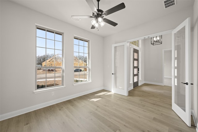 spare room with light wood-type flooring, visible vents, and french doors