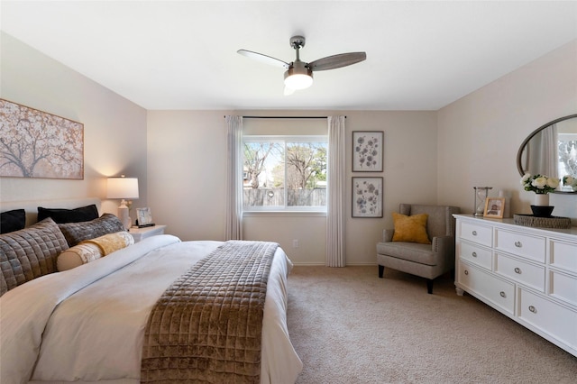 bedroom with light colored carpet, baseboards, and ceiling fan
