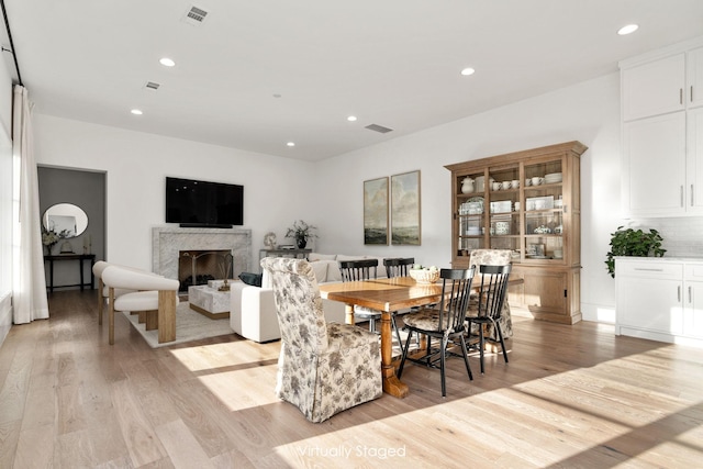 3760 Juniper Dr, Dallas, TX 75220 - dining room with light wood-type flooring, recessed lighting, and a premium fireplace