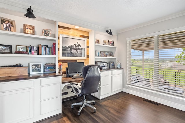 home office featuring visible vents, built in shelves, ornamental molding, a textured ceiling, and dark wood-style floors