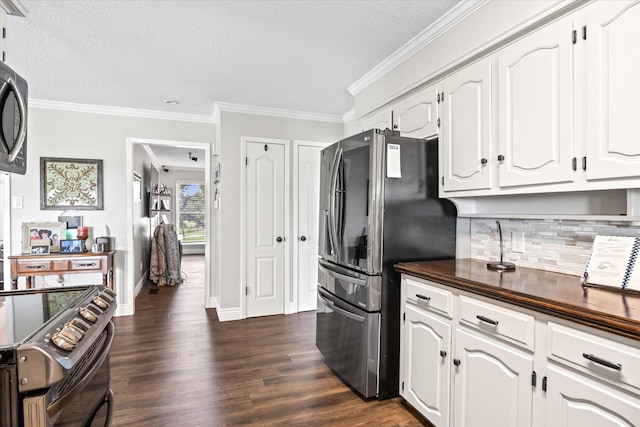 kitchen with crown molding, dark wood finished floors, white cabinets, and freestanding refrigerator