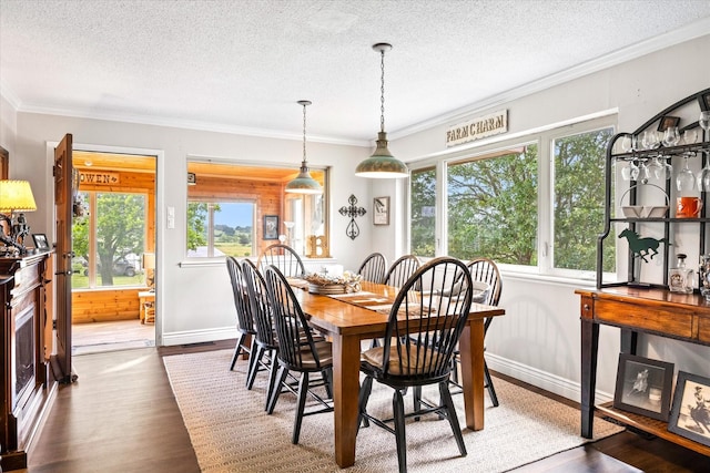 dining space featuring visible vents, baseboards, ornamental molding, a textured ceiling, and dark wood-style flooring