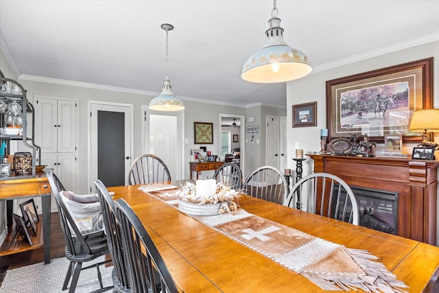 dining area with crown molding and wood finished floors
