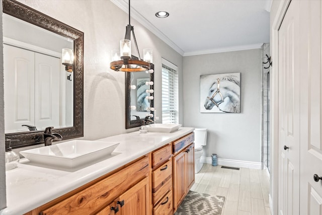 full bath featuring visible vents, crown molding, toilet, double vanity, and a sink
