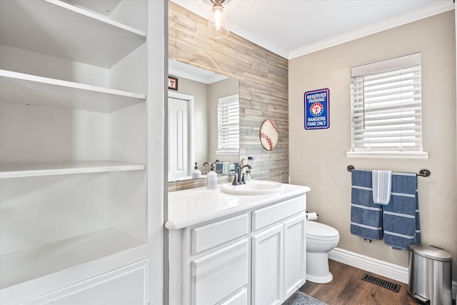 bathroom featuring vanity, wood finished floors, visible vents, crown molding, and toilet