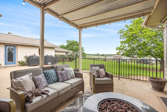 view of patio with an outdoor living space with a fire pit and fence