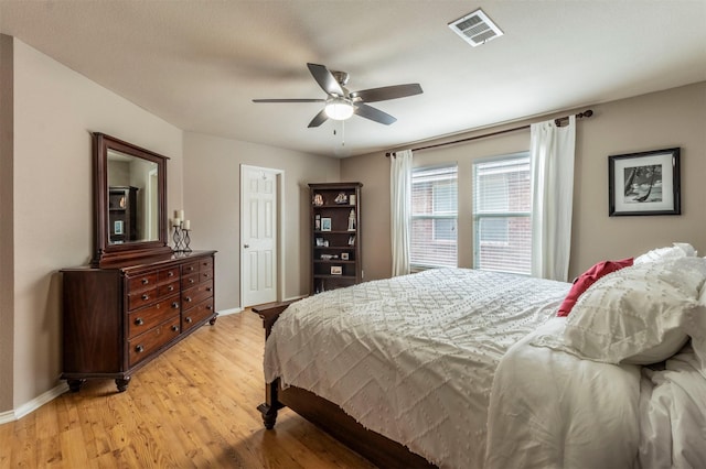bedroom featuring light wood-style floors, baseboards, and visible vents