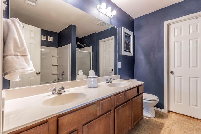 bathroom featuring a sink, tile patterned floors, a stall shower, and double vanity