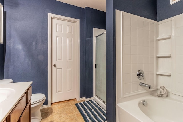 bathroom featuring a bathtub, a shower with shower door, vanity, toilet, and a textured wall