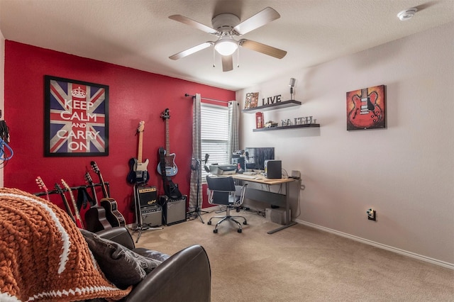 carpeted home office with baseboards and ceiling fan