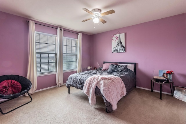 carpeted bedroom with baseboards and a ceiling fan