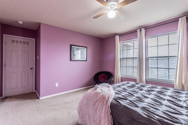 bedroom with baseboards, ceiling fan, and light carpet