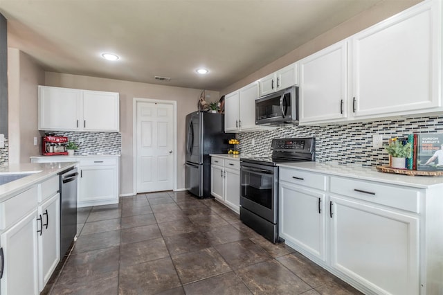 kitchen featuring decorative backsplash, white cabinetry, appliances with stainless steel finishes, and light countertops