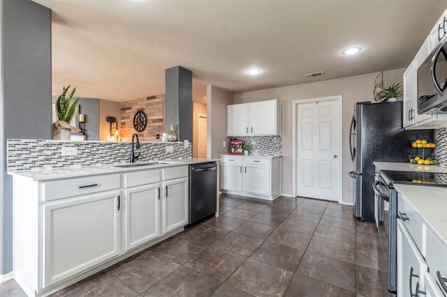 kitchen with backsplash, range with electric stovetop, visible vents, dishwasher, and a sink