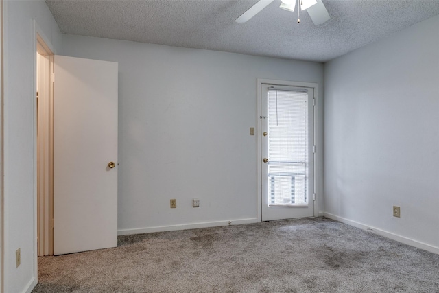 spare room featuring baseboards, carpet flooring, a textured ceiling, and ceiling fan