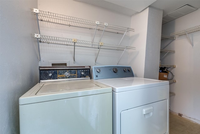 clothes washing area featuring washer and dryer and laundry area