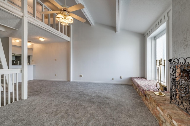 interior space featuring lofted ceiling with beams, baseboards, and ceiling fan