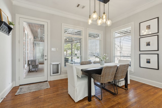 dining area featuring visible vents, a healthy amount of sunlight, and dark wood finished floors