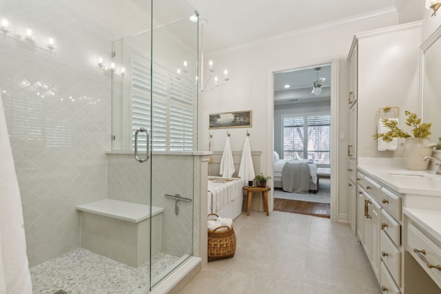 bathroom featuring a stall shower, connected bathroom, ornamental molding, and vanity