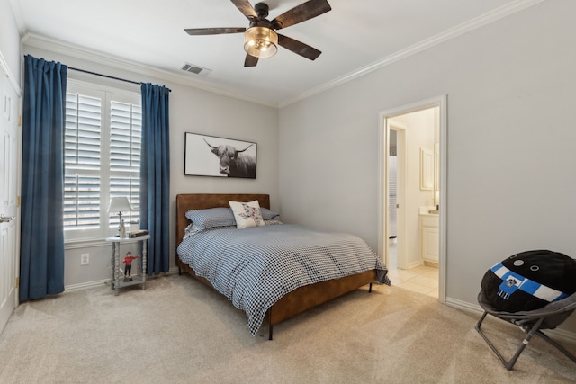 carpeted bedroom featuring visible vents, baseboards, ceiling fan, ornamental molding, and ensuite bath