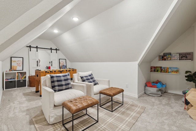 sitting room with baseboards, recessed lighting, vaulted ceiling, light carpet, and a barn door