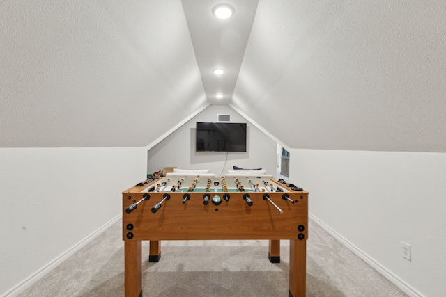 playroom with a textured ceiling, baseboards, lofted ceiling, and carpet floors