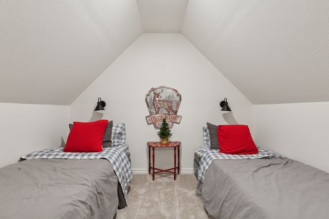 carpeted bedroom with lofted ceiling, baseboards, and a textured ceiling