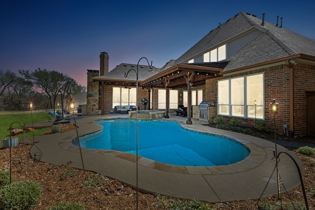 view of pool featuring a patio, grilling area, a pool with connected hot tub, and ceiling fan