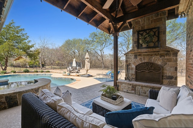 view of patio / terrace with a gazebo, an outdoor living space with a fireplace, a fenced in pool, and fence