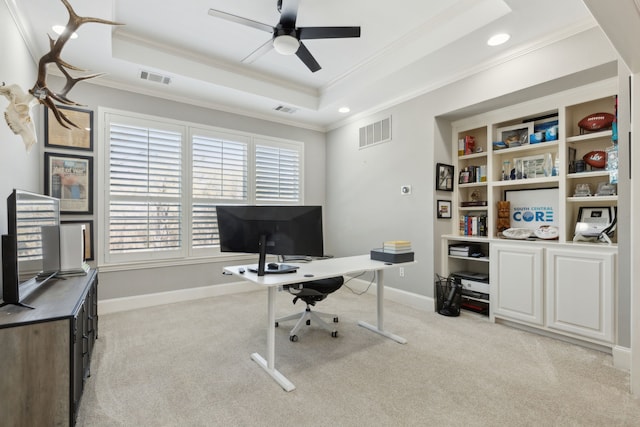 office with light carpet, visible vents, plenty of natural light, and a raised ceiling