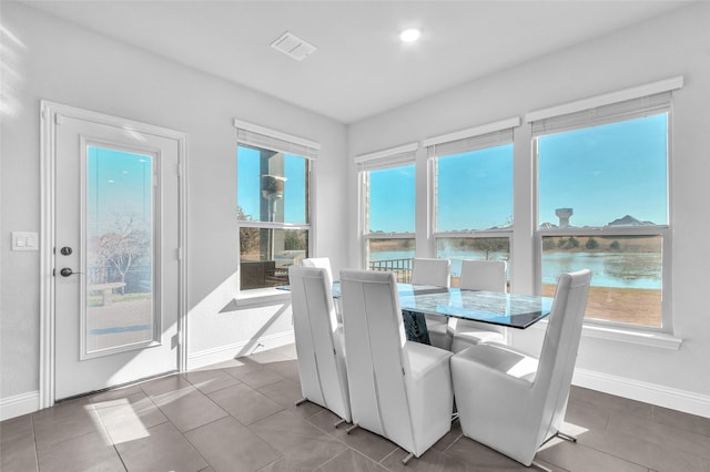 1411 Fishergate Dr, Forney, TX 75126 - dining room with baseboards, healthy amount of natural light, tile patterned floors, a water view, and recessed lighting