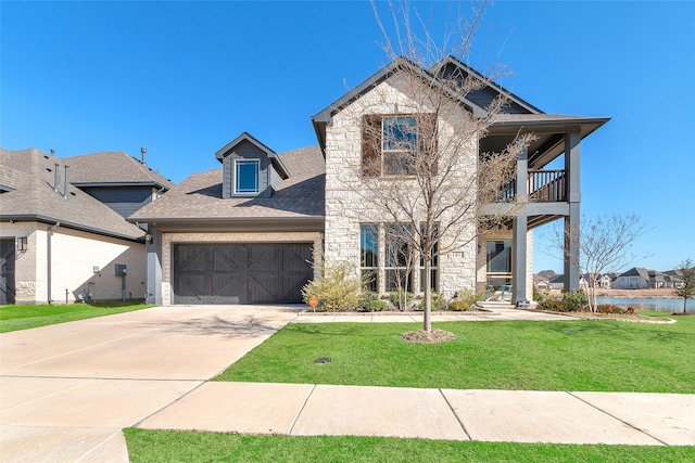1411 Fishergate Dr, Forney, TX 75126 - view of front of home with a balcony, a front yard, an attached garage, driveway, and a shingled roof