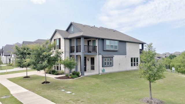 1411 Fishergate Dr, Forney, TX 75126 - back of property featuring a balcony and a lawn