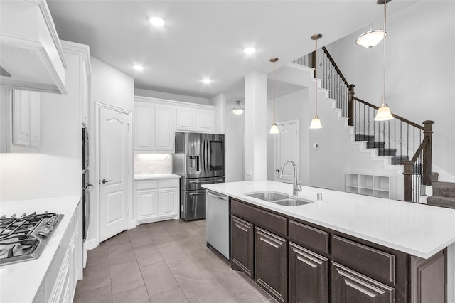1411 Fishergate Dr, Forney, TX 75126 - kitchen with a sink, stainless steel appliances, white cabinetry, dark brown cabinetry, and light countertops