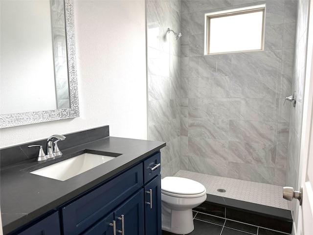 bathroom featuring vanity, toilet, and a stall shower
