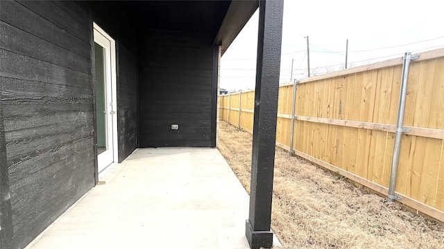 view of patio featuring fence