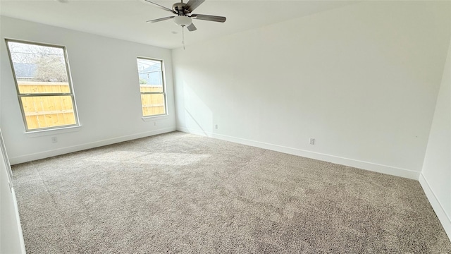 unfurnished room featuring baseboards, a ceiling fan, and carpet flooring