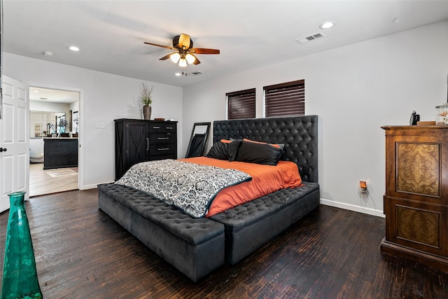 bedroom featuring visible vents, baseboards, and wood finished floors