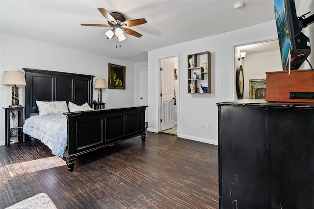 bedroom with a ceiling fan, dark wood-style floors, and baseboards